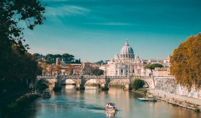 Rome, Italy. Papal Basilica Of St. Peter In The Vatican. Sightseeing Boat Floating Near Aelian Bridge. Tour Touristic Boat