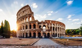 Colosseum in Rome during sunrise. Italy travel destination. Long exposure image with moving clouds.